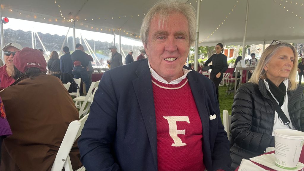 A man shows off his sweater