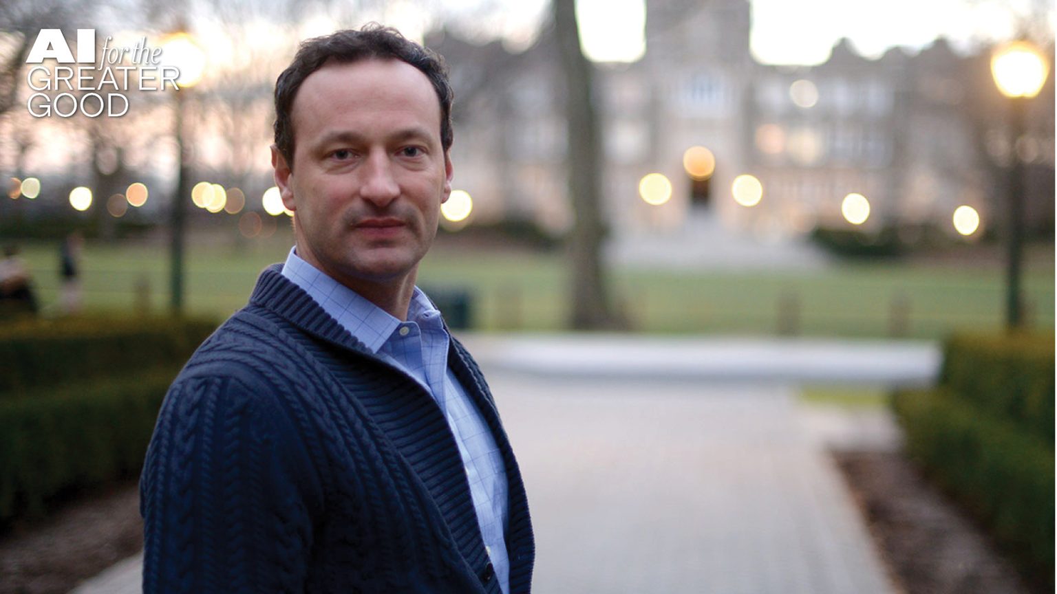A man facing the camera with Keating Hall behind him