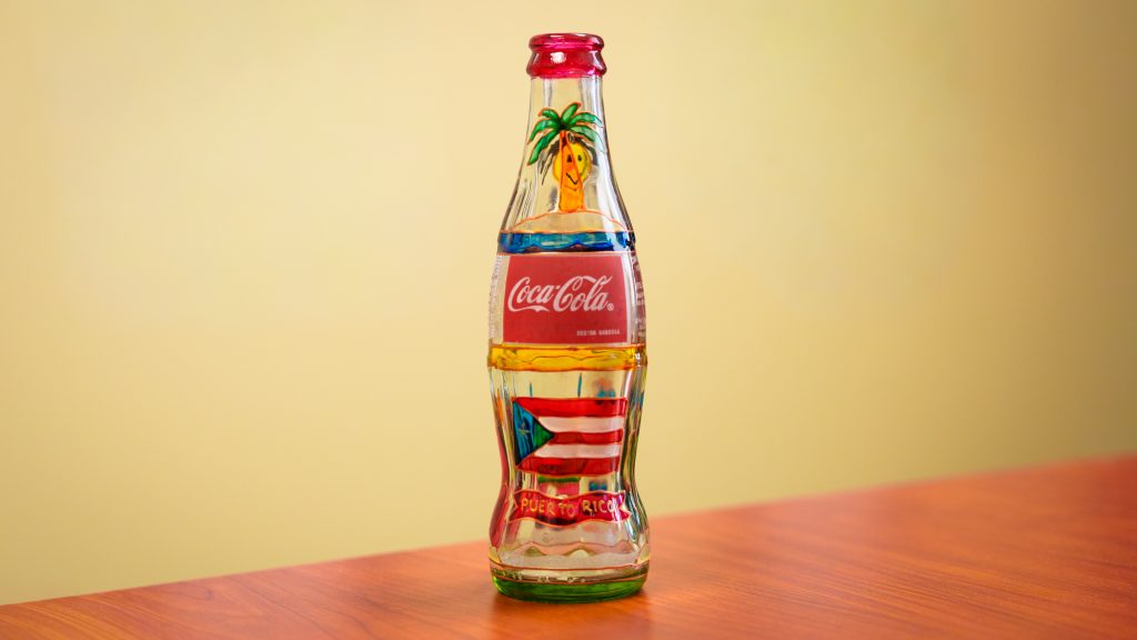A Coca-Cola bottle decorated with images