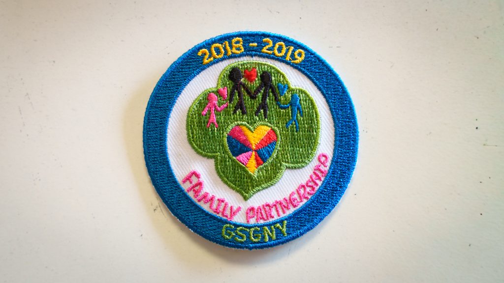 A patch that says "2018-2019 FAMILY PARTNERSHIP GSCNY"