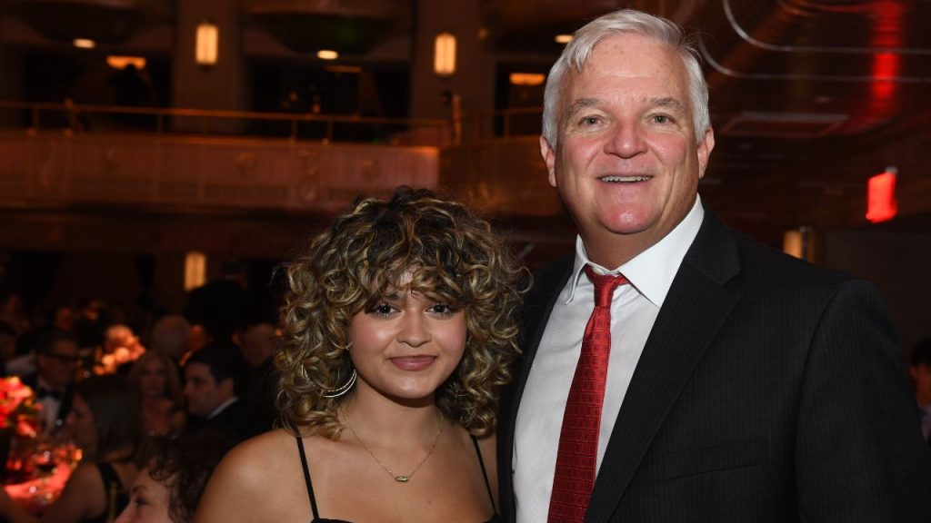 Woman with blond curls with man with white hair