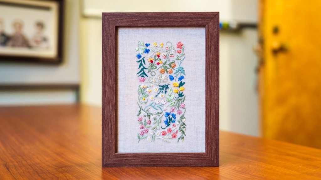 Floral embroidery in a wooden frame