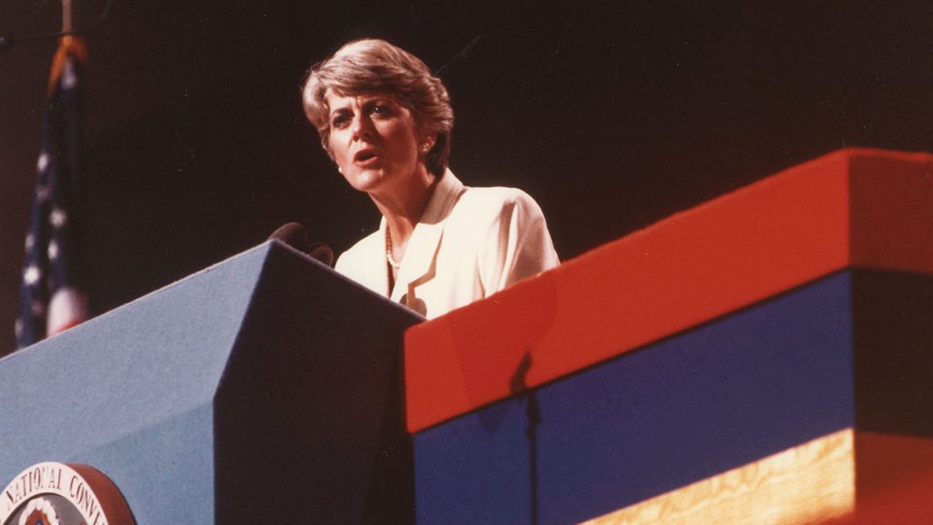 A woman speaks at a podium