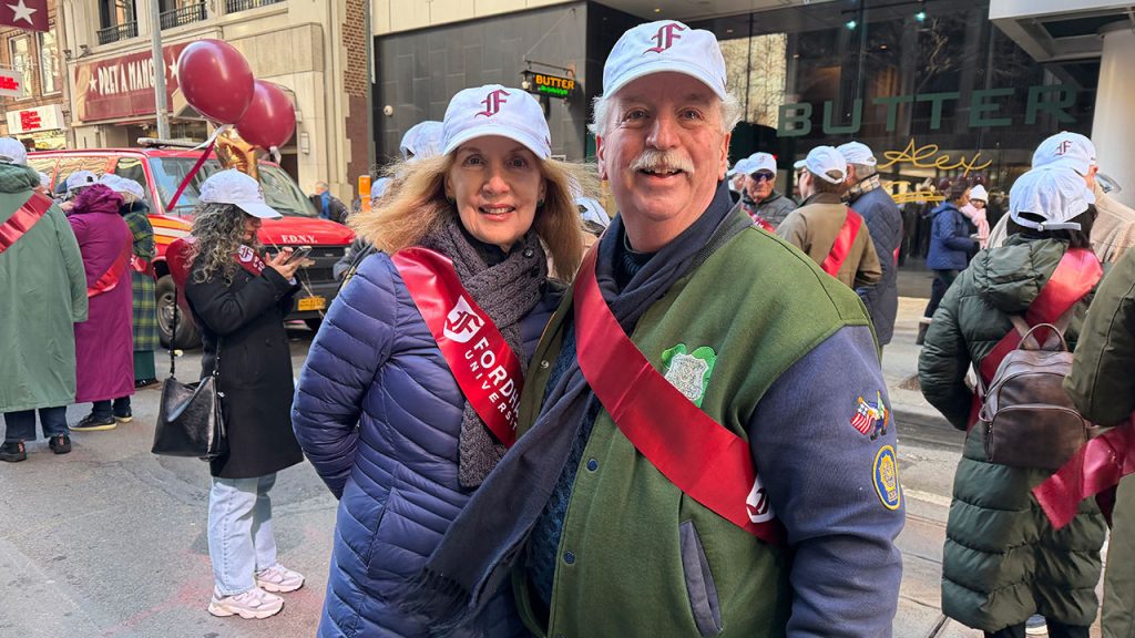 Two people pose at a parade