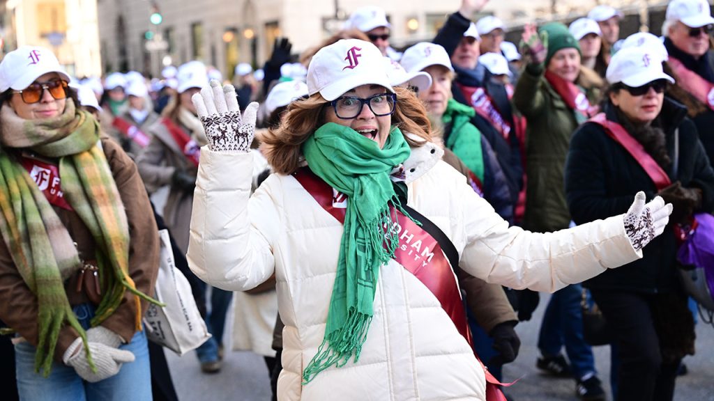 A woman smiles and cheers