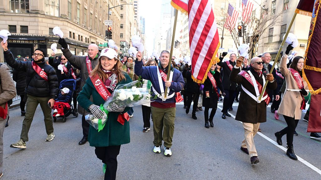 People tip their hats during a parade
