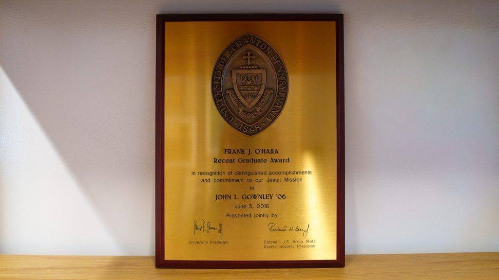 A plaque on a bookshelf