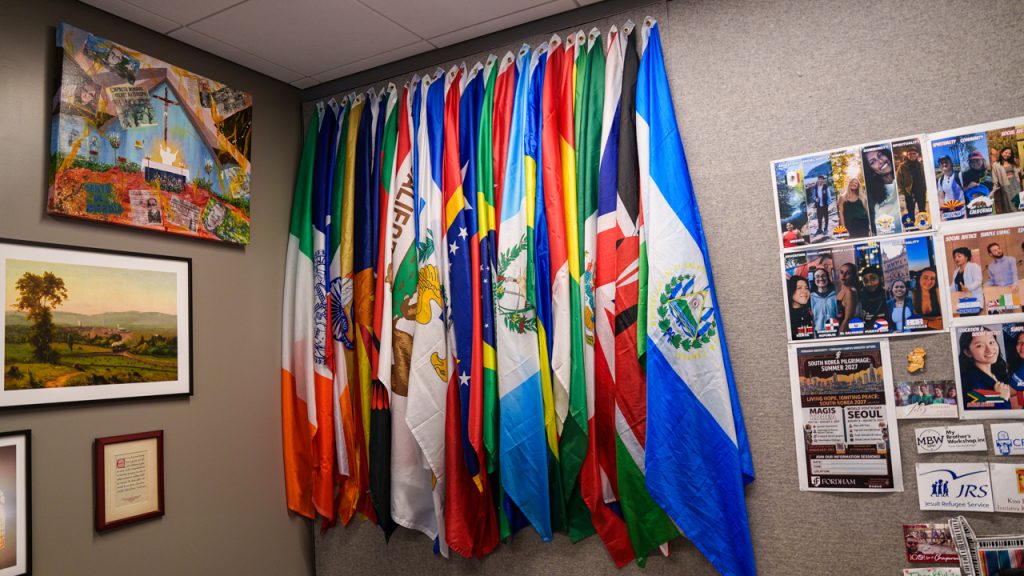 A collection of flags hanging on a wall