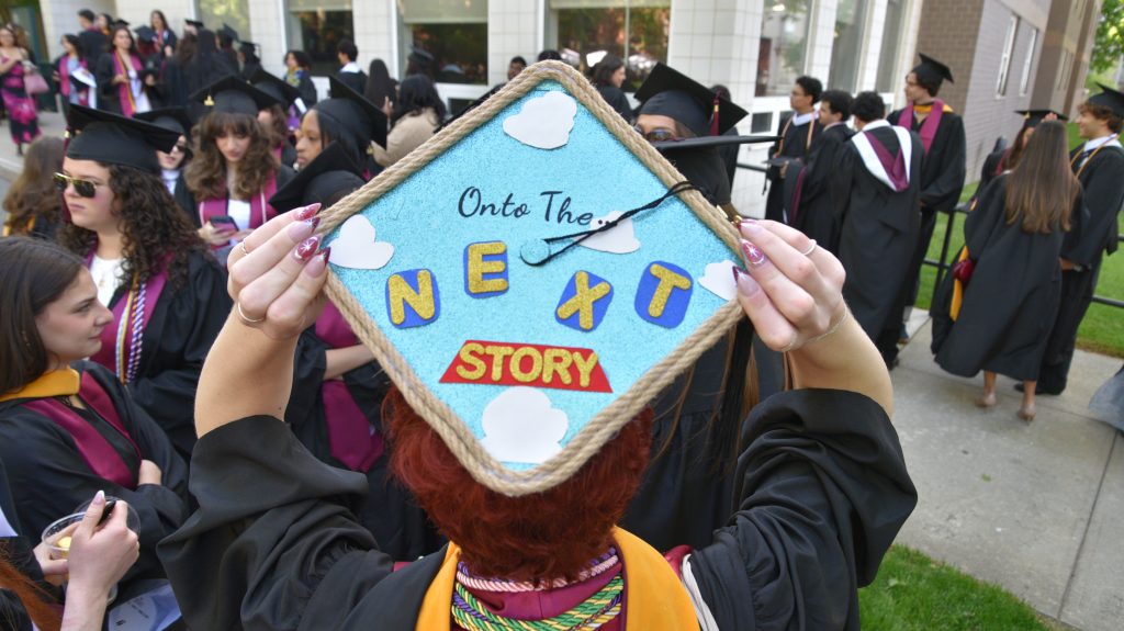 Commencement cap that says "On to the next story"