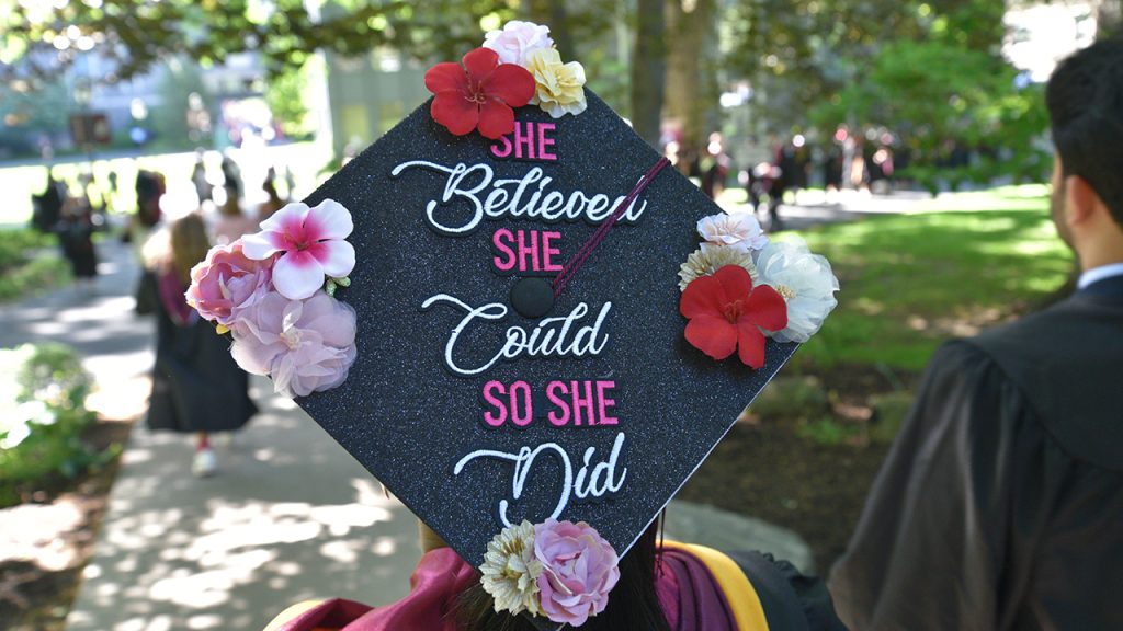 Commencement cap that says "She believed she could so she did"
