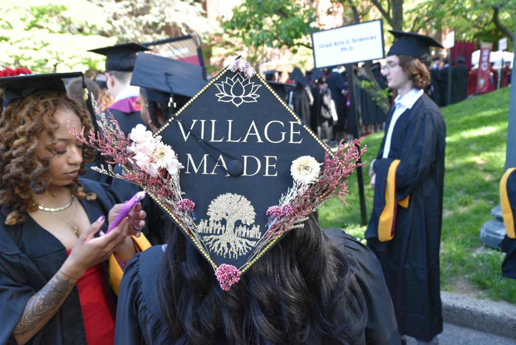 Commencement cap that says "Village made" 