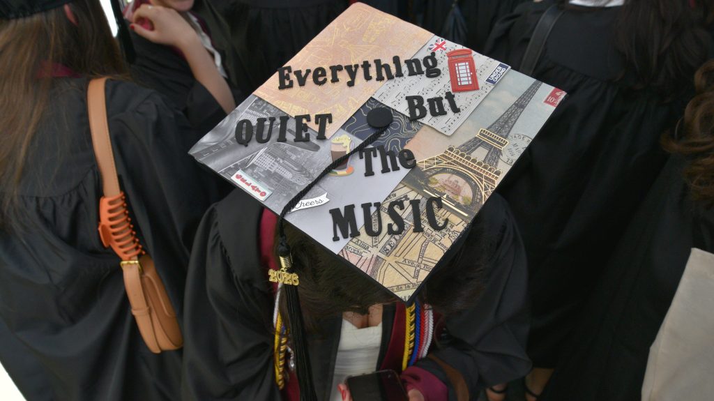 Commencement cap that says "Everything quiet but the music"