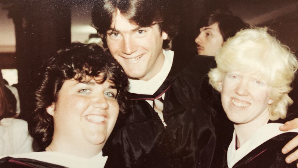 Kathleen Brady posing with friends on graduation day in 1983
