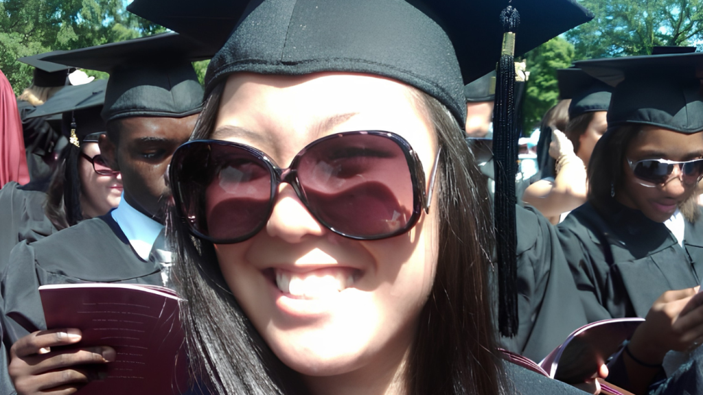 Kelli Singh smiling in cap and gown