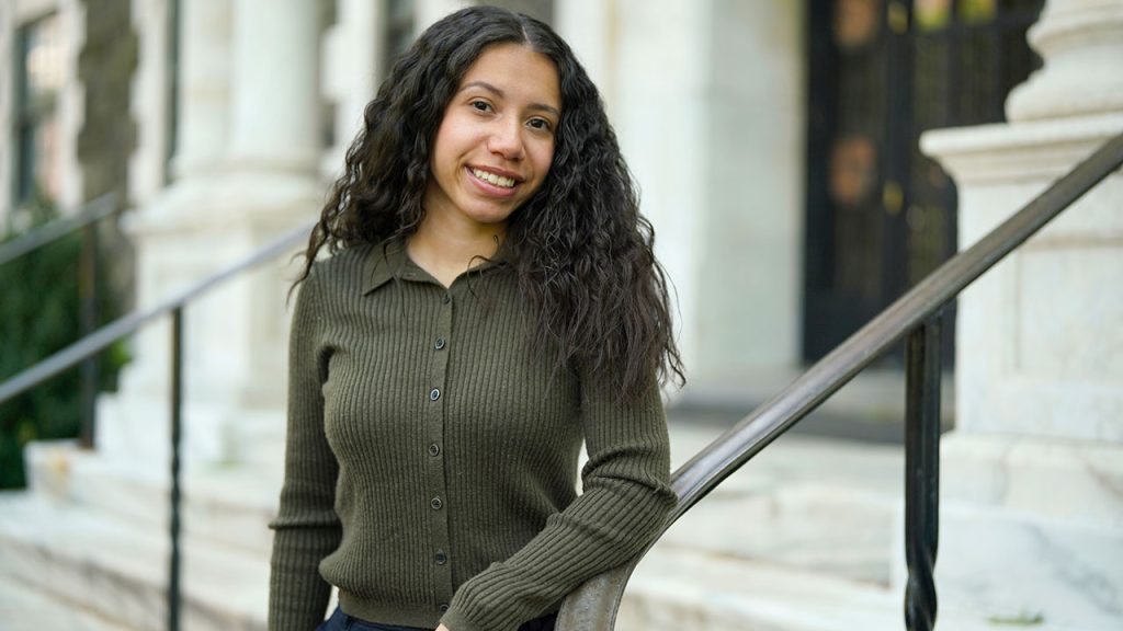 Woman student standing on stone steps