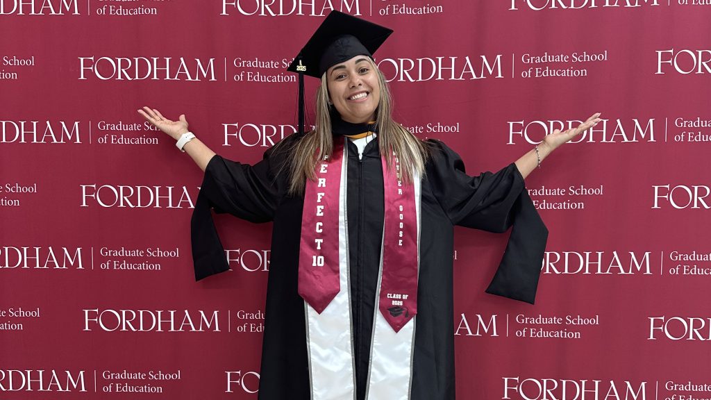 Veronica Pou in front of Fordham Graduate School of Education backdrop