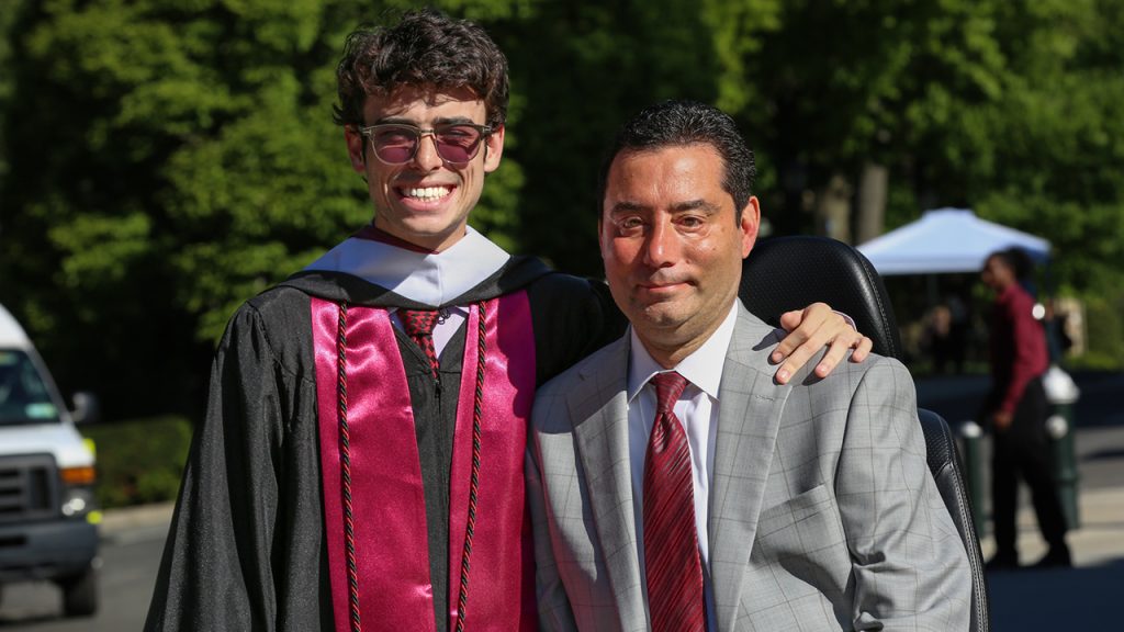 Two men pose for a photo