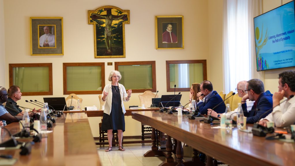 Nathalie Becquart, XMCJ, speaks with a group of seated Fordham trustees.