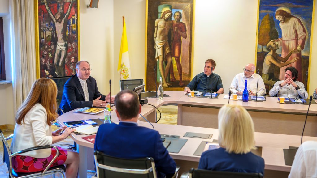 A group of people converse at a table.