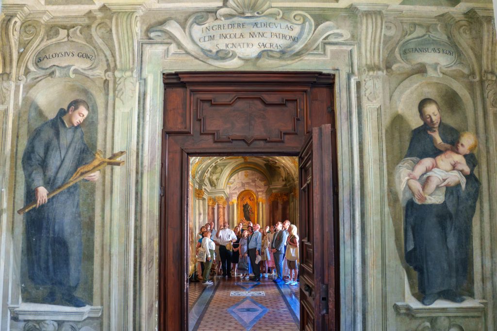 A group of people looking up at the ceiling in awe, framed within a doorway