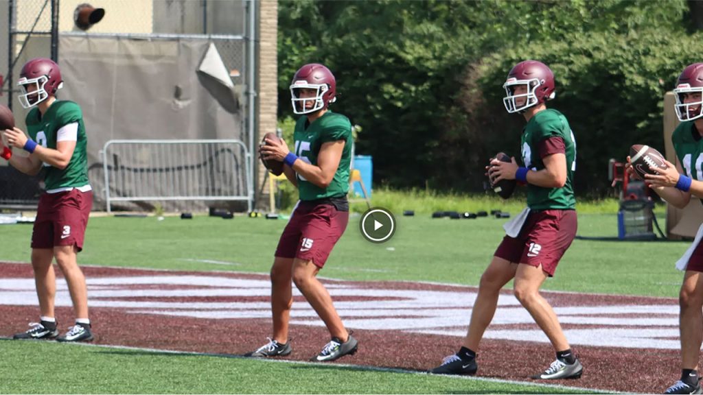 Fordham football players practicing with play button
