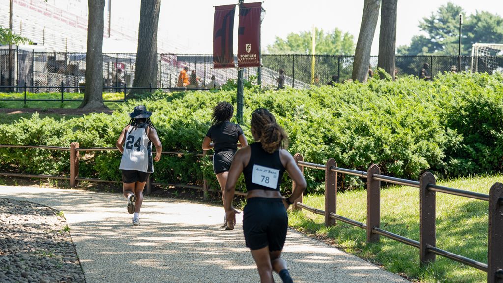 Runners on the sidewalk around Eddies Parade
