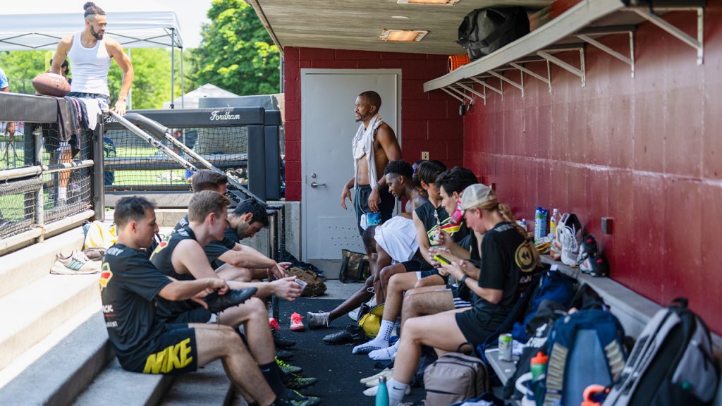 Participants resting in the dugout at Moglia Stadium