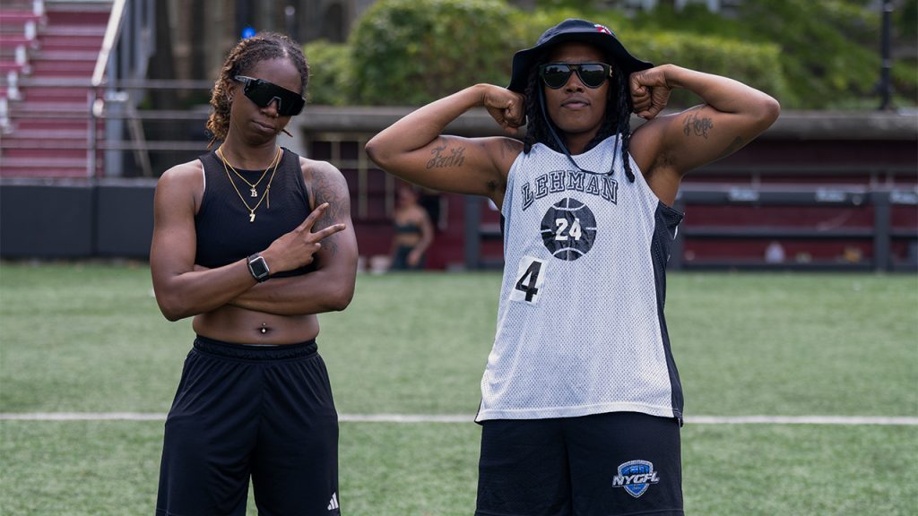 Two participants posing, one making a peace sign and the other flexing