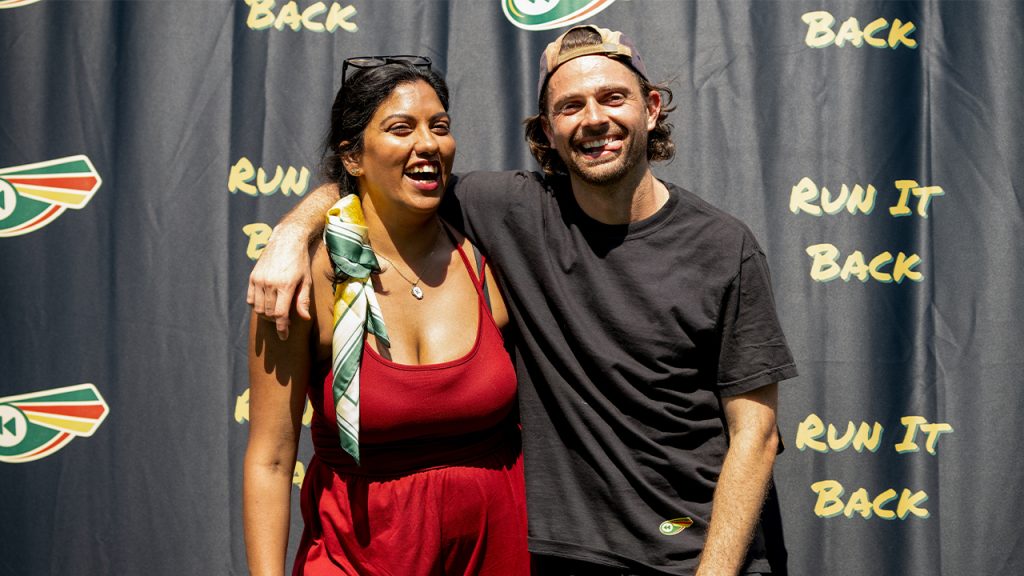 Karishma Kapoor ’15 and Max Peara ’15 posing in front of Run it Back signage