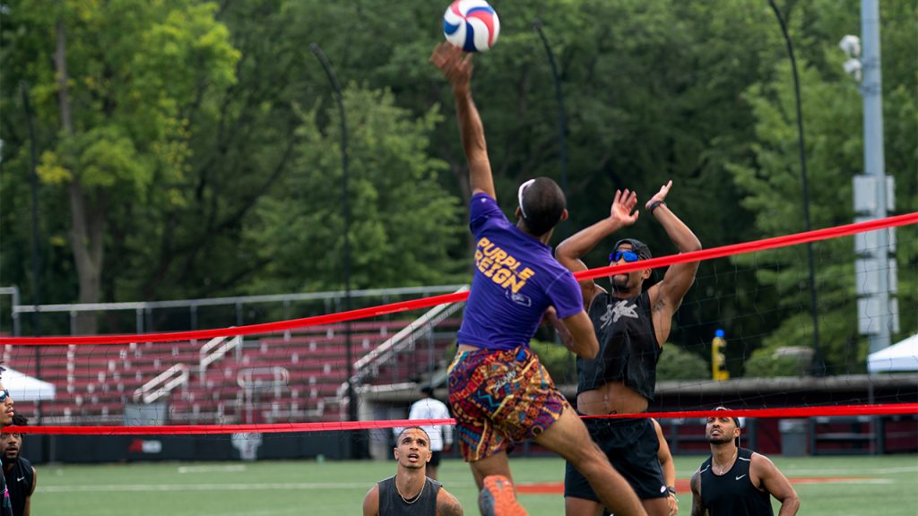 A player spiking the ball over the volleyball net