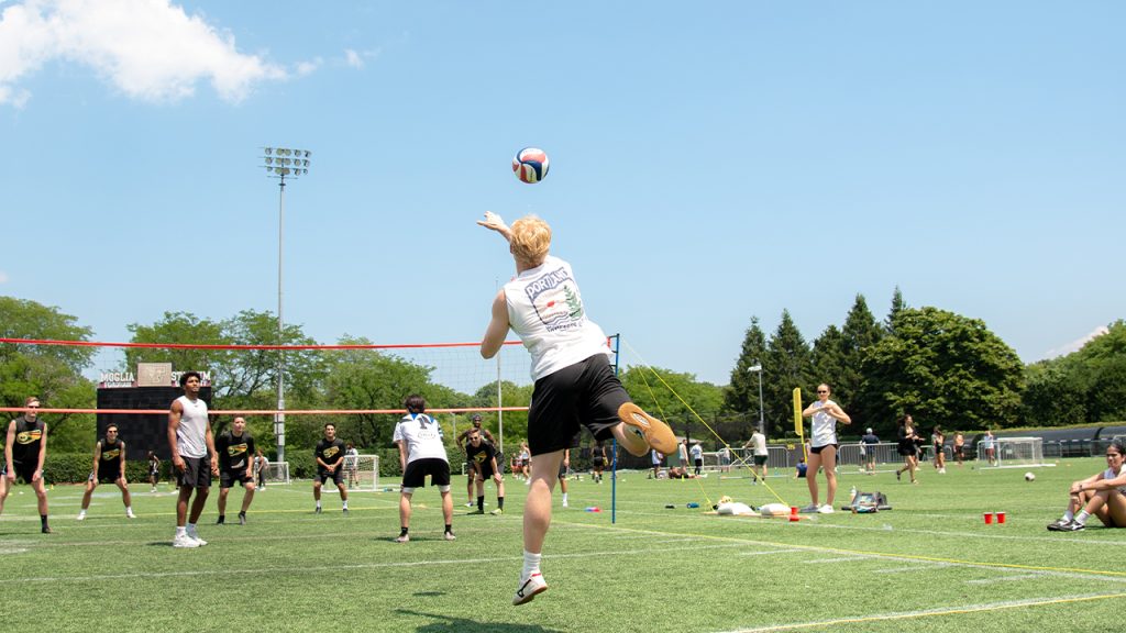 A person serving during a volleyball game