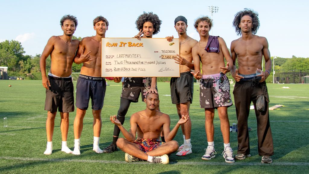 The second-place team, Larpmasters, holding up a check for $2,500