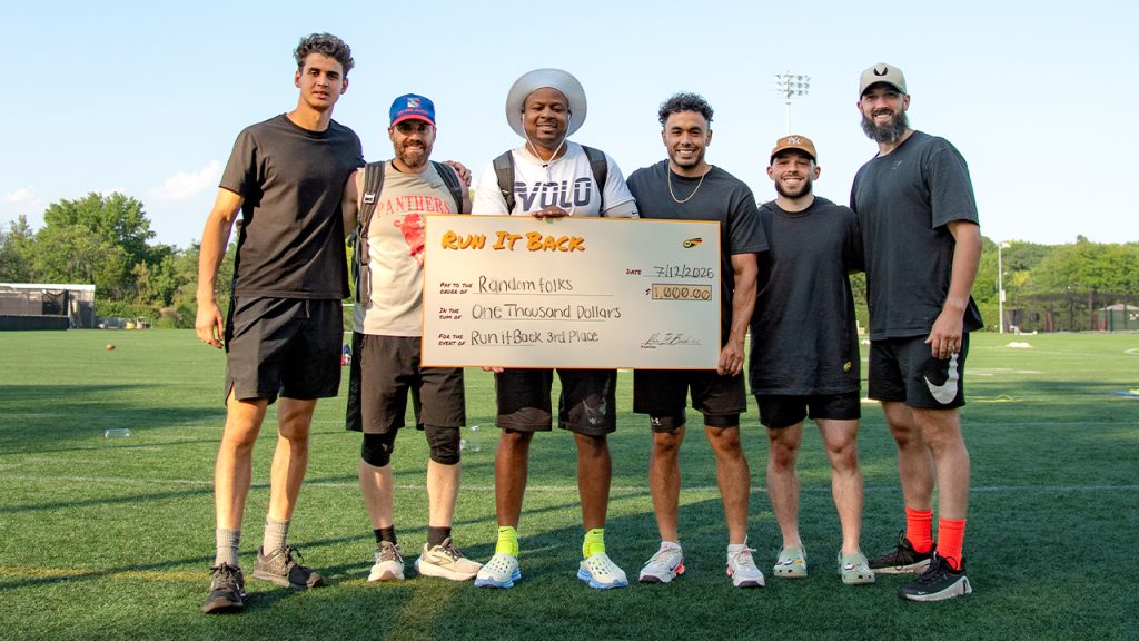 The third place team, Random Folks, holding up a check for $1,000
