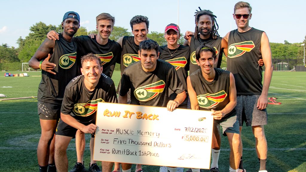 The first-place team, Muscle Memory, holding up a check for $5,000