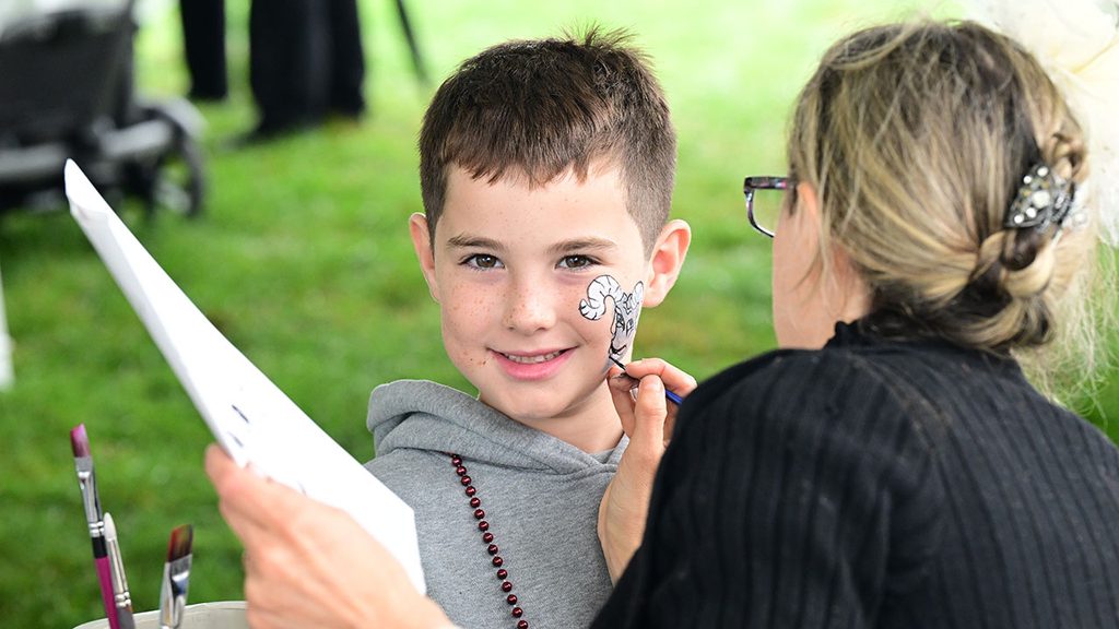little boy getting his face painted