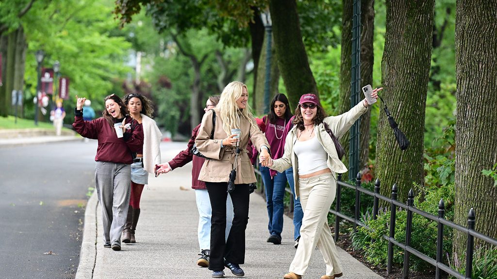 group of friends walking on Fordham Rose Hill campus