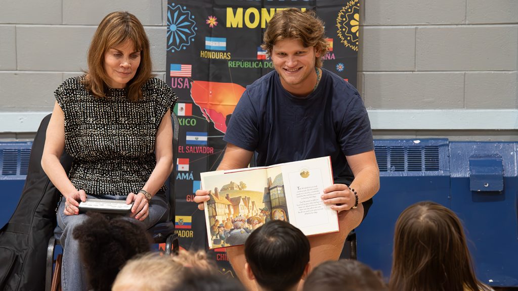 Celebrating the Love of Reading: How Fordham Grows Literacy in Its New York Community Musician Ginny Owens and a Fordham student reading to children at an event