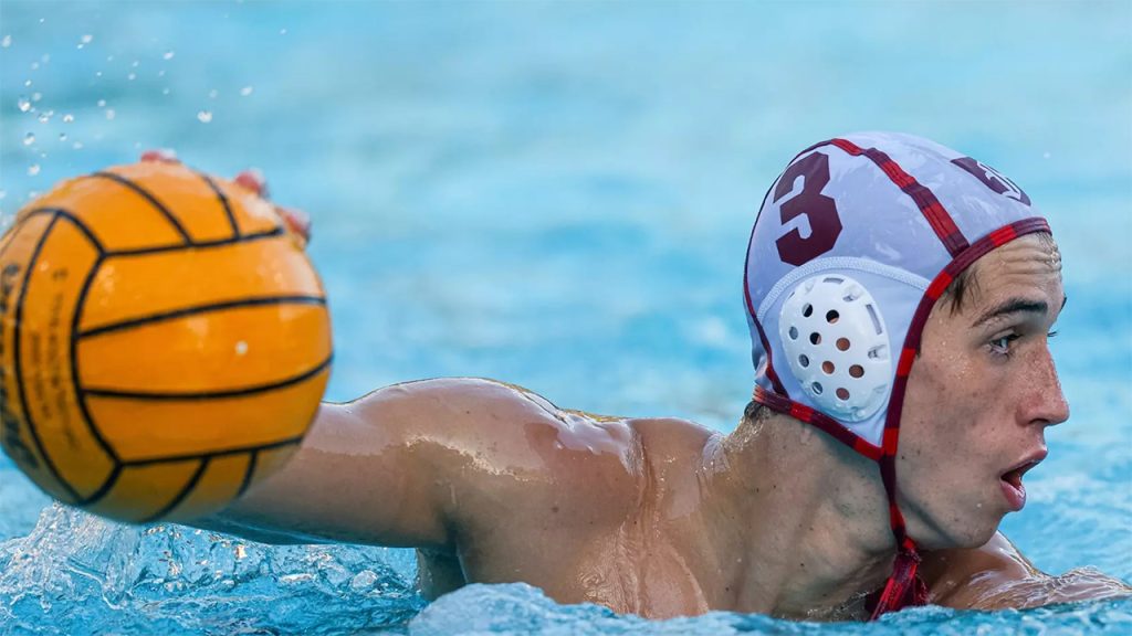 Fordham water polo player Andras Toth in pool with ball
