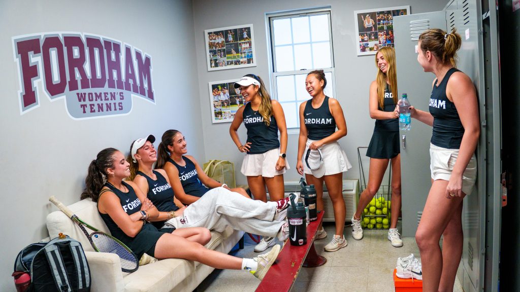 The women's tennis team hanging out in the locker room