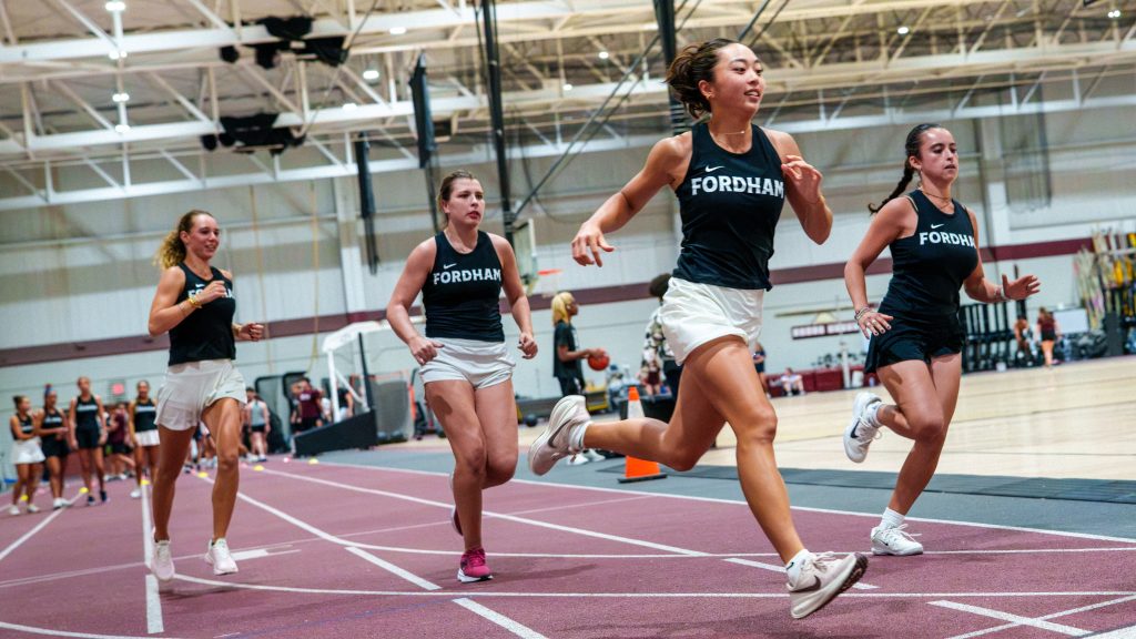 Students run on the track field.