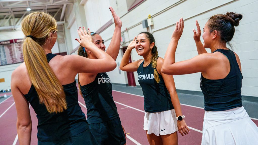 Students high-five each other.